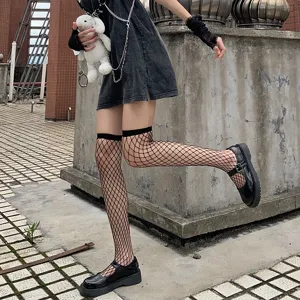 Details of the black fishnet over-the-knee socks showcasing mesh texture and alt fashion styling.