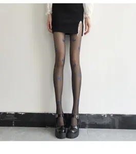 Detailed shot of ultra-thin black sheer pantyhose featuring cute blue butterfly prints.