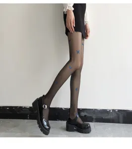Details of sheer black pantyhose featuring cute blue butterfly prints for women, ultra-thin style.