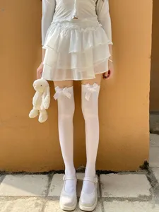 White over-the-knee socks with elegant bow knots, soft velvet texture, sweet jk style detail.