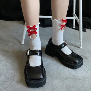 Japanese style sweet white mid-tube socks featuring red velvet bows and cute hollow lettuce edge.