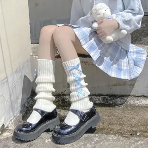 Close-up detail of sweet lolita knitted leg warmers featuring cute blue plaid ribbons.