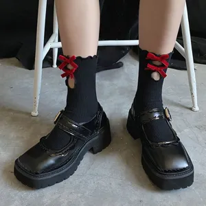 Cute Japanese style mid-calf socks with hollow red velvet bows and lettuce edge trim for daily wear.