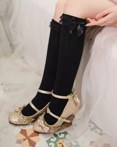 Detail view of black Lolita knee-high socks with delicate lace and sweet bow, charming style.