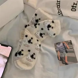 Cozy winter plush socks featuring cute cow print, ultra soft fuzzy material for home warmth.