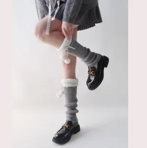 Autumn winter knit leg warmers with fluffy shearling trim and cute pom poms for cozy styles.