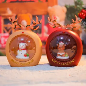 Christmas reindeer night light detail showing cute snowman and deer figurines in snow globe base.