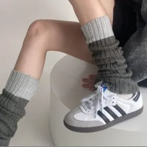 Grey knitted leg warmers for women, cozy winter slouch socks, stylish aesthetic calf warmers.