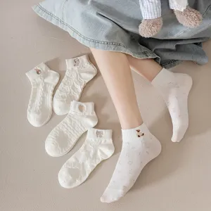 Close-up details of white short socks with cute embroidery and unique 3D jacquard texture.