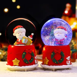 Christmas snow globe ornament with rotating snow and warm LED lights for holiday home decor.