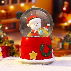 Christmas snow globe decoration with cute Santa Claus figure and festive base details
