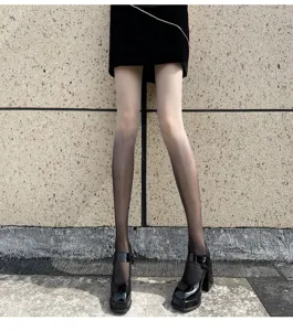 Detailed shot of gradient pantyhose featuring a smooth black-to-nude transition design.