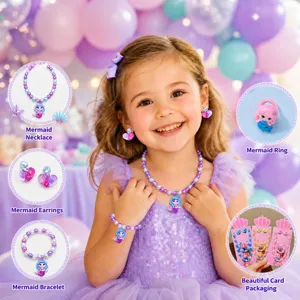 Close-up details of kids mermaid pearl necklace, bracelet, earrings and ring set, cute pink packaging.