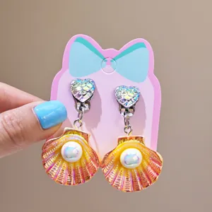 Children clip-on earrings feature cute heart shell faux pearl design, perfect for party dress up.
