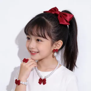 Details of sweet children pearl jewelry set with red bow headband, necklace, bracelet and ring.