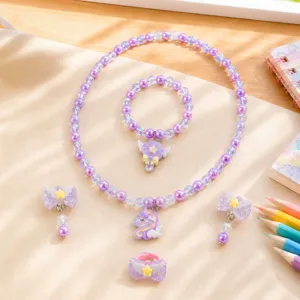 Close-up details of cute children's unicorn pendant and purple pearl jewelry set display.