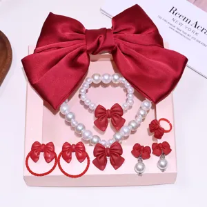Kids red bow pearl jewelry set details, featuring necklace bracelet hair clips and cute rings.