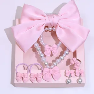 Children pink bow imitation pearl jewelry set detail showing necklace bracelet ring earrings