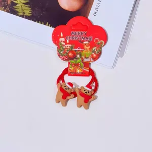 Christmas bear hair ties detail, cute brown bear hair rope with festive holiday packaging.