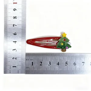 Kids Christmas tree hairpin detail view, red metal BB clip with cute holiday decoration size.
