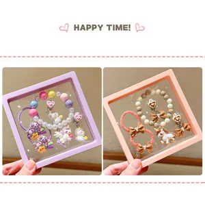 Detailed view of cute children jewelry gift box featuring unicorn bracelets and hair ties.