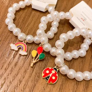 Cute pearl bead bracelets with rainbow and ladybug pendants for student daily wear style.