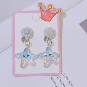 Close-up detail of cute glitter star clip-on earrings for kids, sparkling resin design.