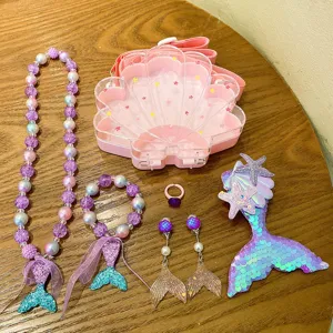 Kids mermaid jewelry set featuring shell bag, beaded necklace, bracelet, earrings and hair clip.