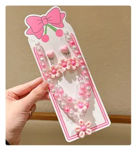 Kids pink pearl necklace and clip-on earrings set with cute flower pendant and bow display card.