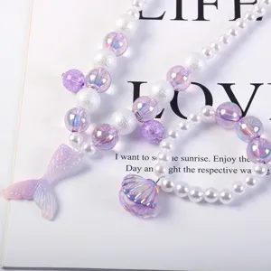 Detailed view of the children pearl necklace and seashell bracelet set with mermaid theme.