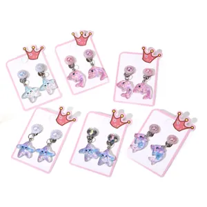 Cute kids clip-on earrings set with cartoon starfish and dolphin designs on crown cards for girls.