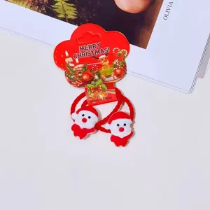 Kids Christmas hair ties with cute Santa resin charms and red elastic hair ropes for styling.