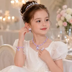 Close-up detail shot of cute unicorn pearl jewelry set featuring necklace and earrings on model.