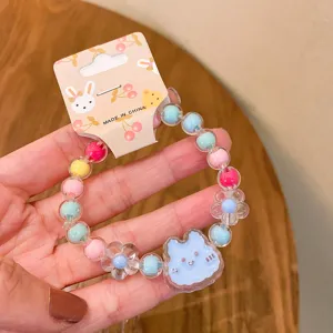 Detailed close-up of cute kids jelly beaded bracelet with adorable cartoon pendant for girls.