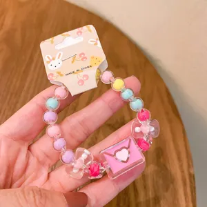 Cute jelly bead bracelet detail showing pink envelope charm and colorful translucent beads.