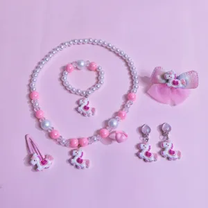 Kids pink unicorn jewelry set main view with necklace bracelet hair clips and cute accessories.