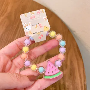 Cute children colorful bead bracelet with watermelon pendant detail view, lovely summer jewelry.