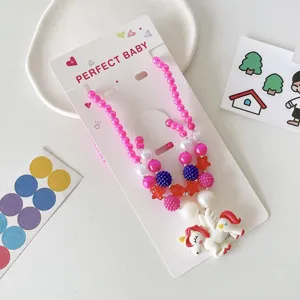Kids bead necklace detail view, colorful DIY jewelry set with cute unicorn pendant and bracelet.