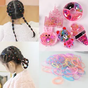 Colorful rubber hair bands for kids with cute cartoon storage boxes for styling.