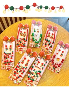 Detailed view of children's Christmas necklace and earring sets featuring festive holiday charms.