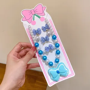 Children pearl necklace set with blue bow pendant, cute fairy style jewelry detail view.