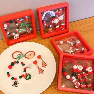 Christmas children jewelry set detail showing cute Santa and snowman resin charms and bracelets.