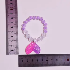 Detail view of children mermaid tail beaded bracelet, size measurement display with rulers.