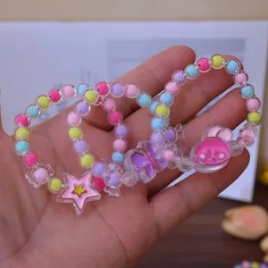 Close-up detail of cute colorful jelly bead bracelets for kids with cartoon charms.