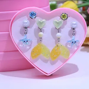 Cute children clip-on earrings and ring set, featuring sparkling mermaid tail designs.