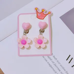 Children's sweet pink clip-on earrings with cute heart and flower charms for girls.