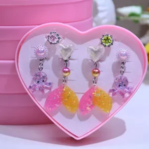 Details of cute kids clip-on earrings and rings set featuring mermaid tail and octopus.