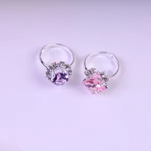 Detail shot of cute children's adjustable crystal rings set featuring colorful gemstone designs.