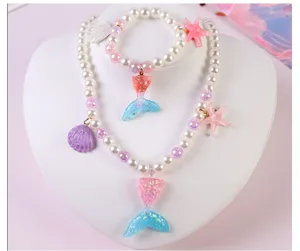 Children mermaid necklace bracelet set with pearls, shells and cute glitter tail pendants.