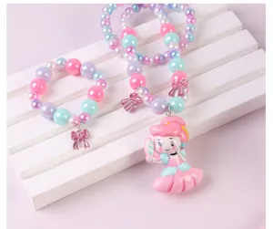 Children mermaid necklace bracelet set detail view, pink and blue beads with cute princess pendant.